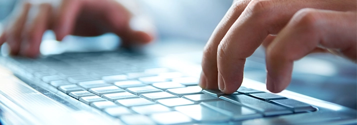 A close-up of someone typing on a keyboard.