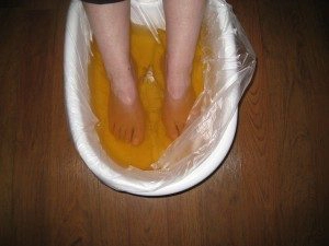 An ionic foot detox spa treatment. A person has their feet in a foot bath.