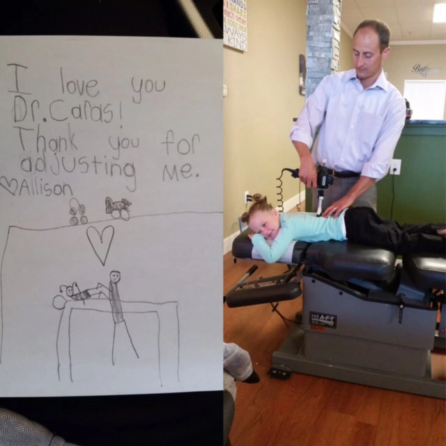Nick Caras adjusting a young girl. Besides the photo is a note she wrote. It says. I love you Dr. Caras! Thank you for adjusting men.